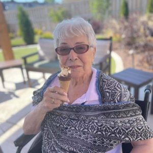Resident eating ice cream on patio