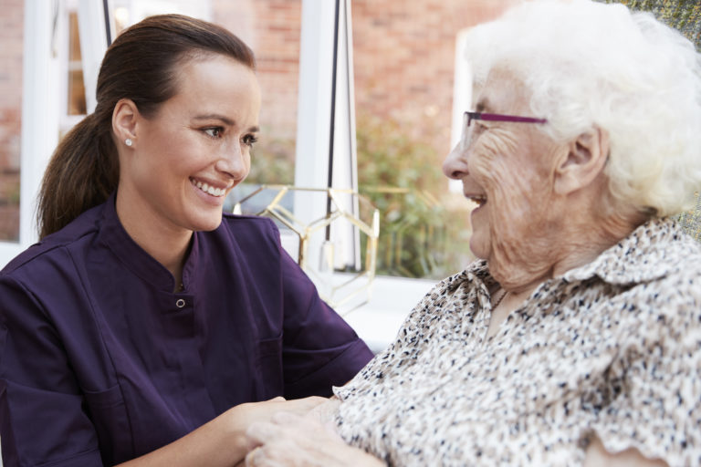 Young female smiling at elderly woman
