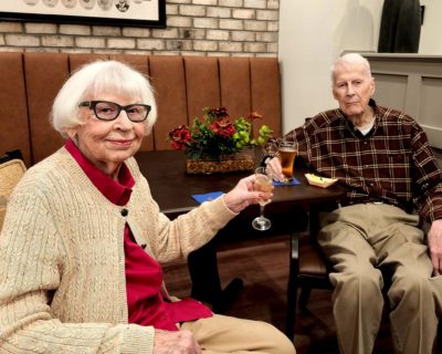 Senior couple smilng and holding drinking glasses