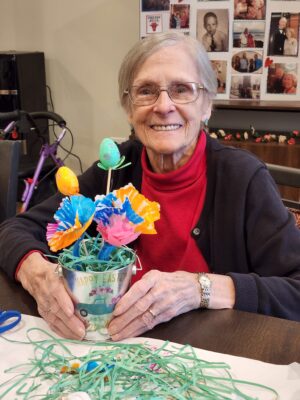 Senior woman smiling with Easter craft