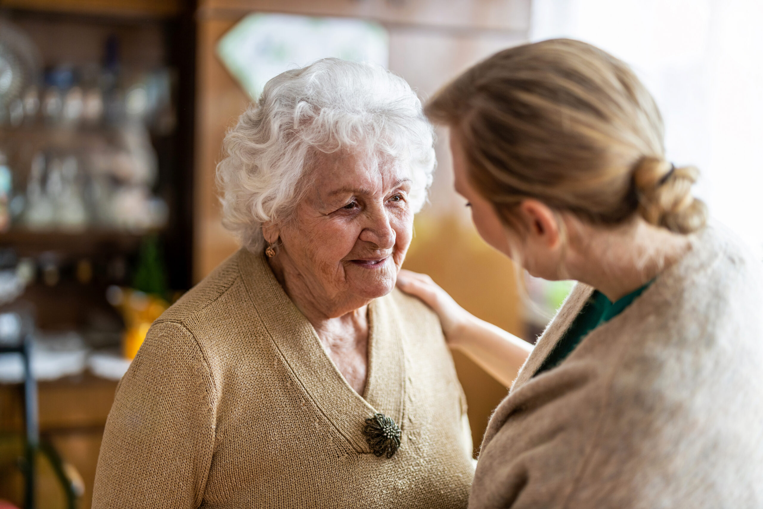 young woman talking to senior woman