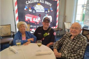 Firefighter at dining table with senior couple