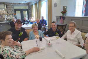 Firefighter at dining table with group of seniors