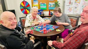 Group of seniors playing colorful card game